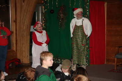 Santa and Mrs. Claus speaking in front of children at the Nature Center